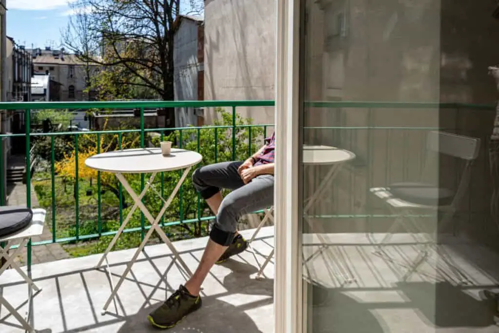 Person sitting on clean balcony.