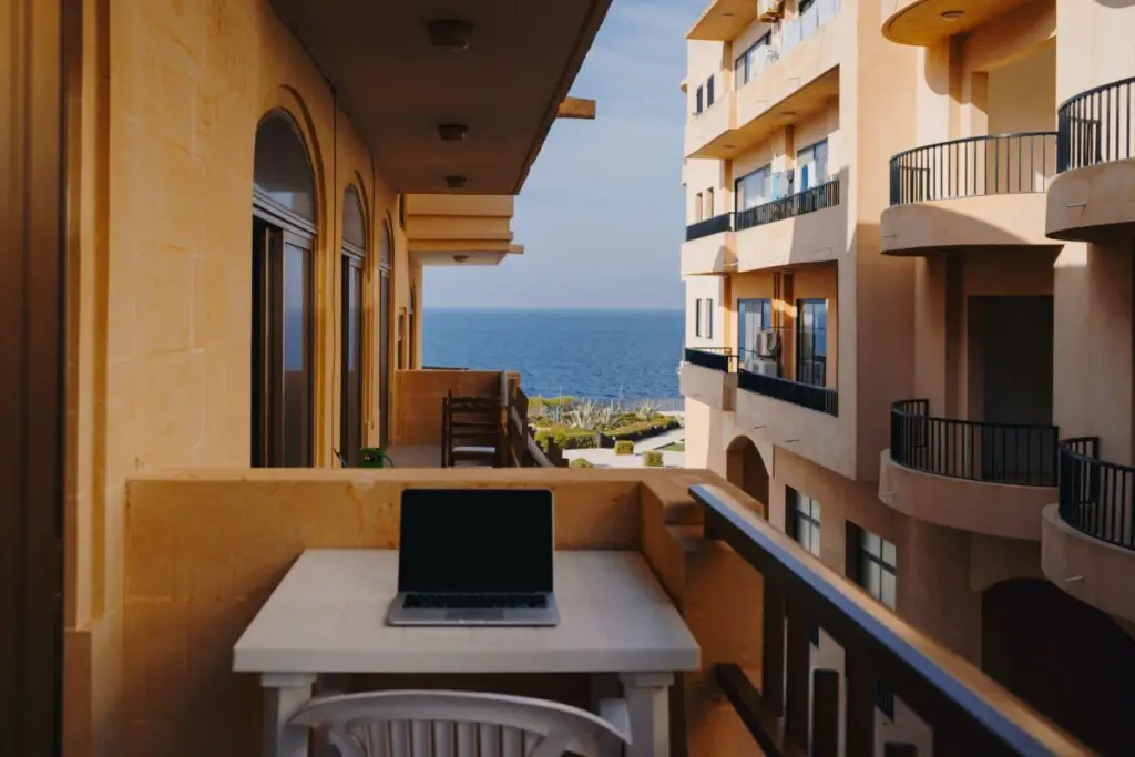 working on a laptop on a balcony